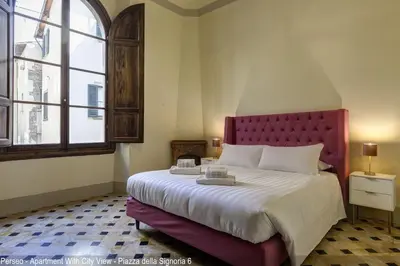 Letto o letti in una camera di Le Farine della Signoria Apartments by Mamo Florence