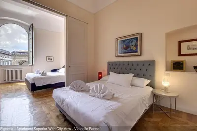 Letto o letti in una camera di Le Farine della Signoria Apartments by Mamo Florence