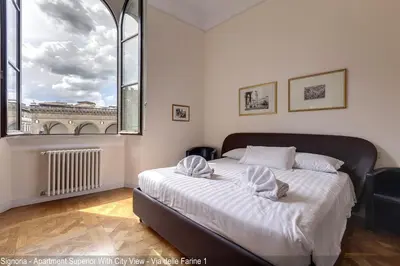 Letto o letti in una camera di Le Farine della Signoria Apartments by Mamo Florence
