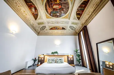 Letto o letti in una camera di Palazzo Alfieri - Place of Charme