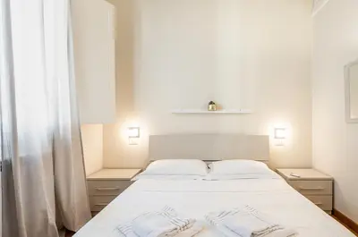 Letto o letti in una camera di GuestHost - La Corte del Re - Piazza della Libertà Apartment