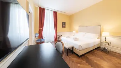 Letto o letti in una camera di Algilà Luxury Torrigiani Apartments