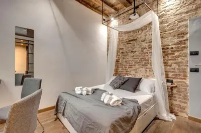 Letto o letti in una camera di Vigna Vecchia Studio by Mamo Florence