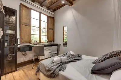 Letto o letti in una camera di Vigna Vecchia Studio by Mamo Florence