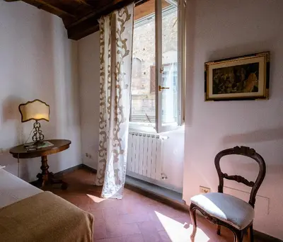 Letto o letti in una camera di Acacia Firenze - Adelfa