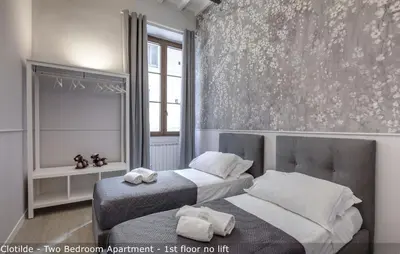 Letto o letti in una camera di Tamara & Clotilde Apartments by Mamo Florence
