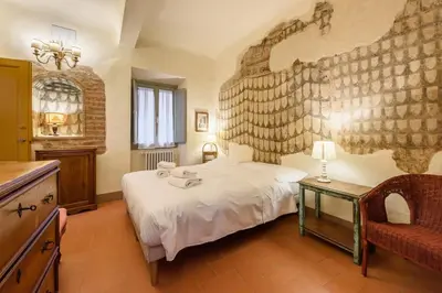 Letto o letti in una camera di Casa torre via de' Nerì by Mmega