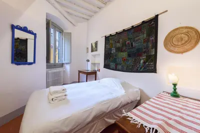 Letto o letti in una camera di Casa torre via de' Nerì by Mmega