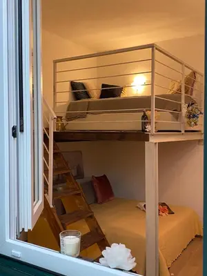 Letto o letti in una camera di Appartamento “Le Tre Sorelle “