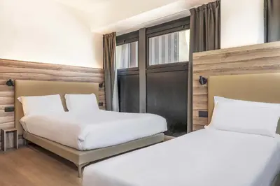 Letto o letti in una camera di B&B HOTEL Prato City Center