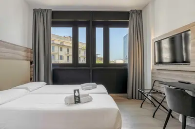 Letto o letti in una camera di B&B HOTEL Prato City Center