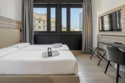 Letto o letti in una camera di B&B HOTEL Prato City Center