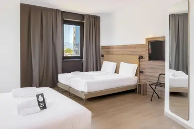 Letto o letti in una camera di B&B HOTEL Prato City Center