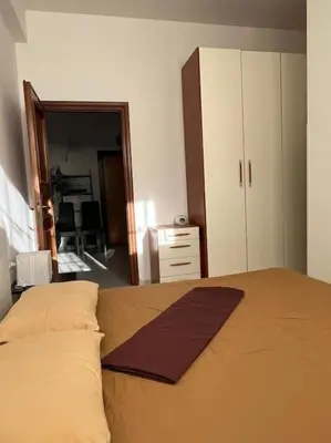 Letto o letti in una camera di Bilocale confortevole a due passi dalla stazione