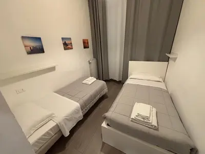 Letto o letti in una camera di HAPPY HOLIDAYS FLORENCE