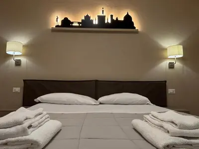 Letto o letti in una camera di HAPPY HOLIDAYS FLORENCE
