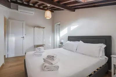 Letto o letti in una camera di Palazzo Borghese Apartment with Panoramic Terrace