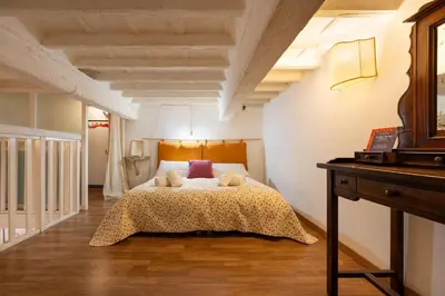 Letto o letti in una camera di Keys of Italy - Laura 34 - Monolocale soppalcato centrale e silenzioso