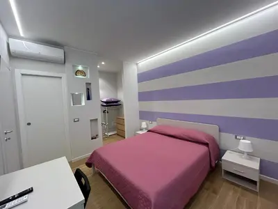 Letto o letti in una camera di Etrusco Viola - Suite Giglio Rosso