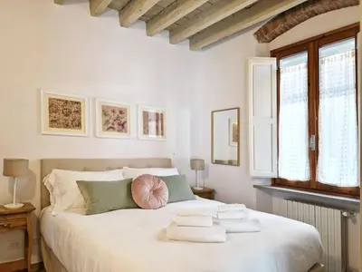 Letto o letti in una camera di Angolo al Giardino delle Rose