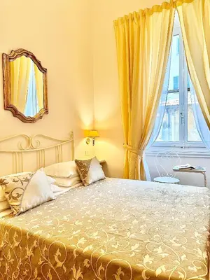 Letto o letti in una camera di B&B Casa Moscato Firenze