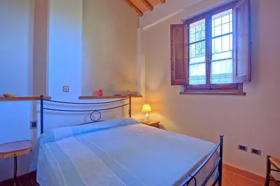 Letto o letti in una camera di Castello di Montegufoni by PosarelliVillas