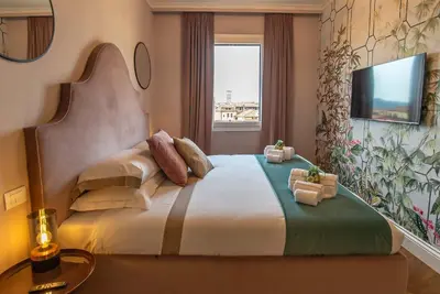 Letto o letti in una camera di Acciaiuoli Penthouse Florence Terrace View