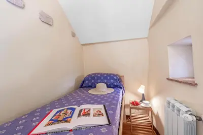 Letto o letti in una camera di Cozy Trekking Home La Via degli Dei - Happy Rentals