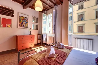 Letto o letti in una camera di Dimora Ognissanti Apartment by Mamo Florence