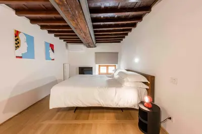 Letto o letti in una camera di appartamento palazzo bardi apartments n 2