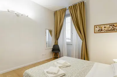 Letto o letti in una camera di GuestHost - Giardino della Fortezza Modern Apt x6 with Patio
