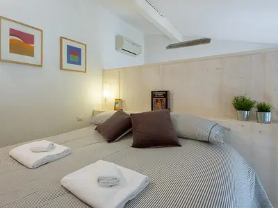 Letto o letti in una camera di San Lorenzo Bright Loft