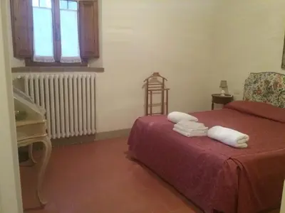 Letto o letti in una camera di Casale La Fornace nel Chianti