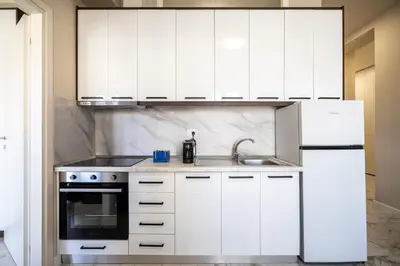 Cucina o angolo cottura di Maragliano Prestige Apartments - A Due Passi dalla Tramvia