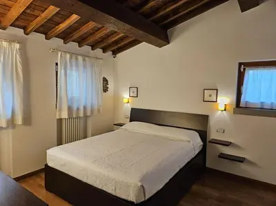 Letto o letti in una camera di Casina Rossa