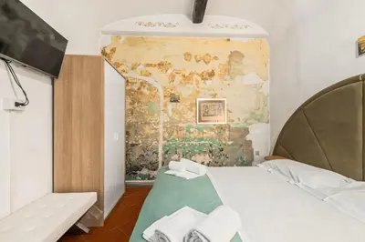 Letto o letti in una camera di Oltrarno Artisan Residence C&G