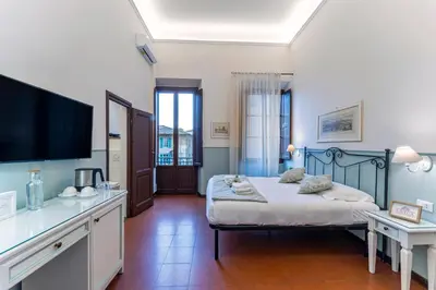 Letto o letti in una camera di UNYCA- Florence Residenza Storica