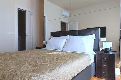 Letto o letti in una camera di Terrazze Raffaello - Attico vista Duomo