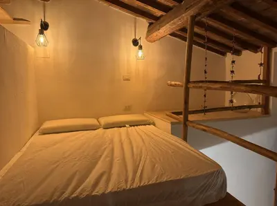 Letto o letti in una camera di Rustico monolocale soppalcato a Firenze