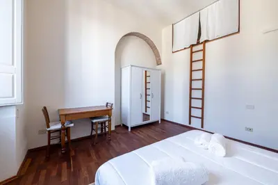 Letto o letti in una camera di Oasi Brunelleschi - 20 Passi da Piazza del Duomo