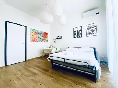 Letto o letti in una camera di M4 WHITE Monolocale Moderno e Funzionale
