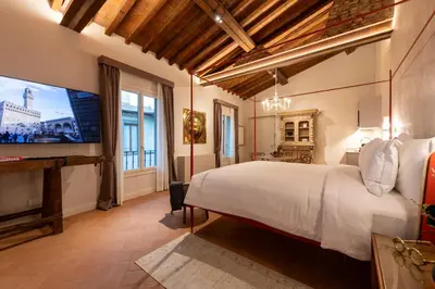 Letto o letti in una camera di Palazzo Doni by Florence Art Apartments