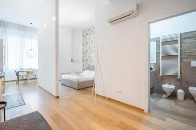 Letto o letti in una camera di Loft Moderno a due passi dalla Tranvia 1BDR