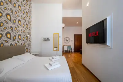 Letto o letti in una camera di Loft Moderno a due passi dalla Tranvia 1BDR