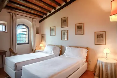Letto o letti in una camera di Castello di Montemasso B&B