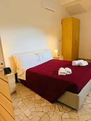 Letto o letti in una camera di Il Novellino Apartment By Rjgal B&B