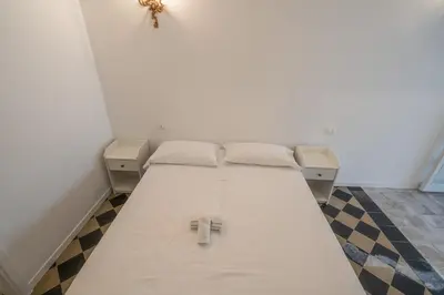 Letto o letti in una camera di Grande e luminoso appartamento in centro