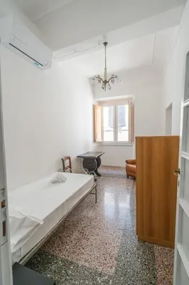 Letto o letti in una camera di Grande e luminoso appartamento in centro