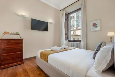 Letto o letti in una camera di GOLDEN LUXE - 2 camere con vista sul Duomo