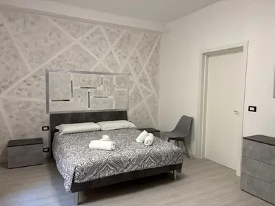 Letto o letti in una camera di Modern Apartment Soggiorno Giovanni dalle bande Nere